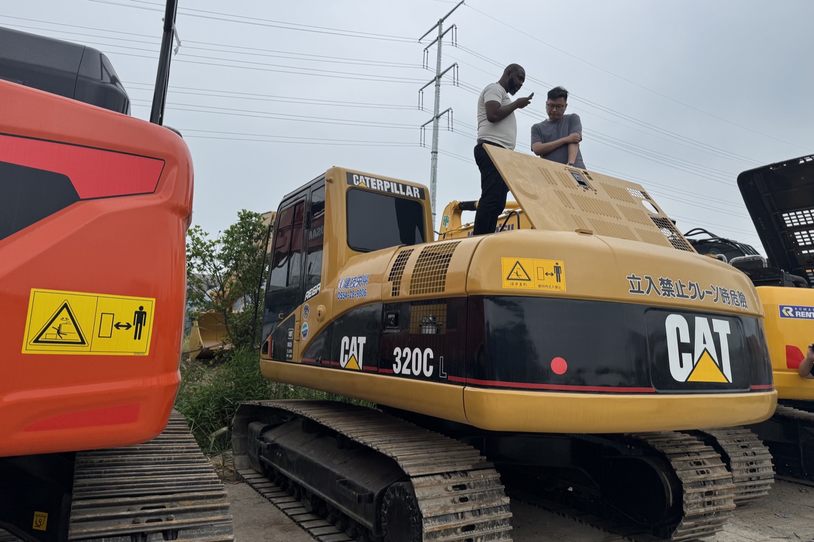 Overseas buyer checking machines at the machinery yard