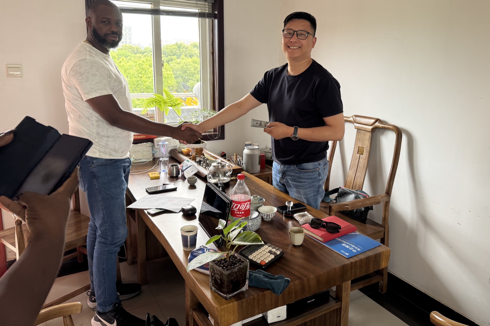 Buyer and sales team confirming used machinery deal